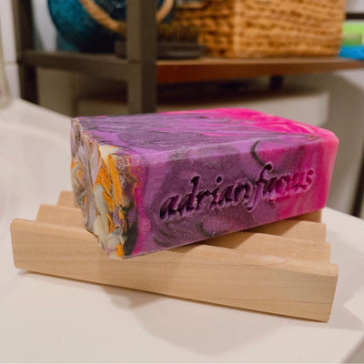 Wooden soap dish with raspberry vanilla soap on top