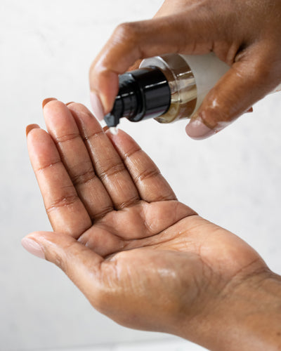 Lavender body oil being poured into hands